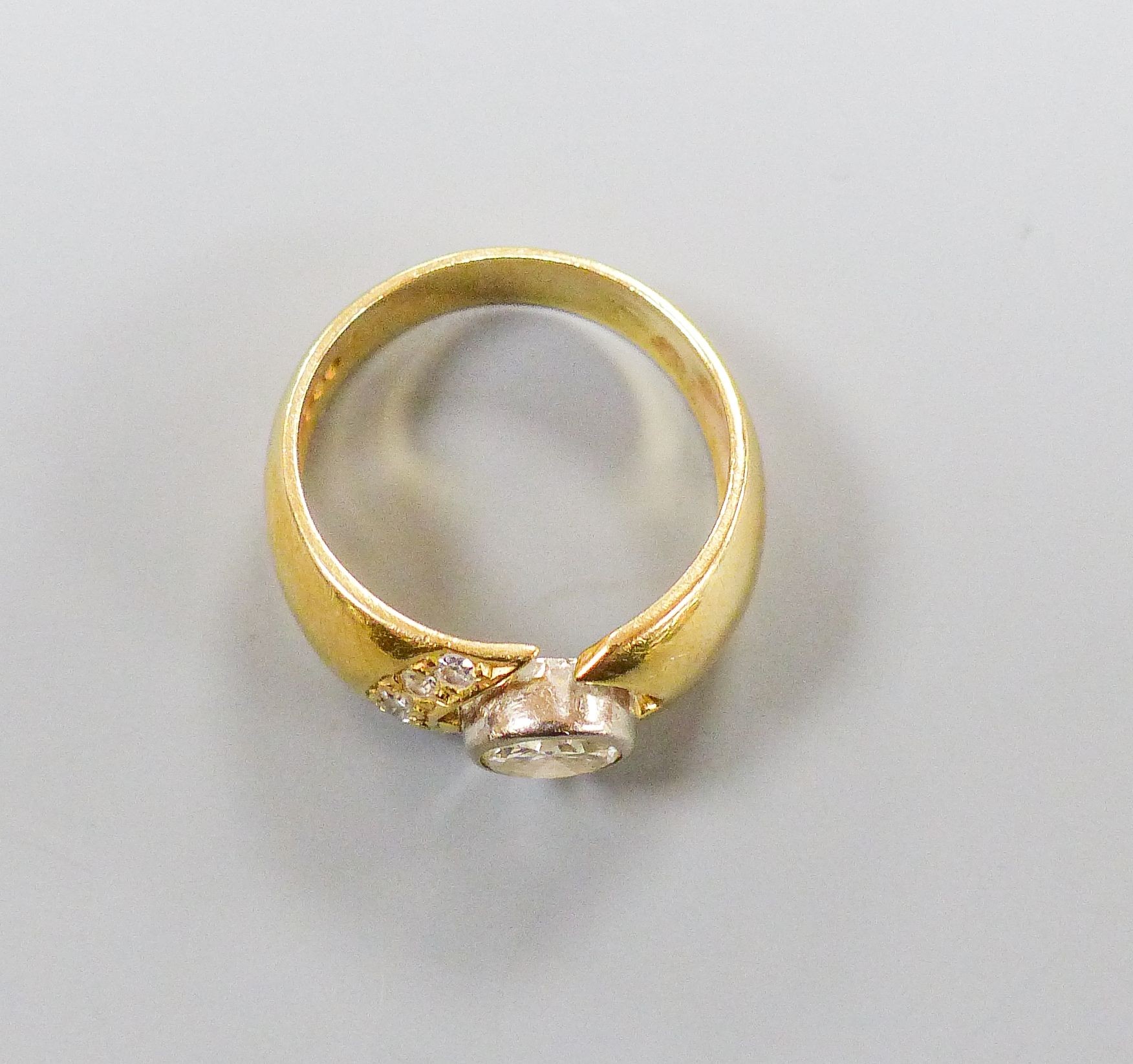 A modern 750 yellow metal and single stone diamond ring, with diamond set open work setting, size M, gross 6.4 grams.